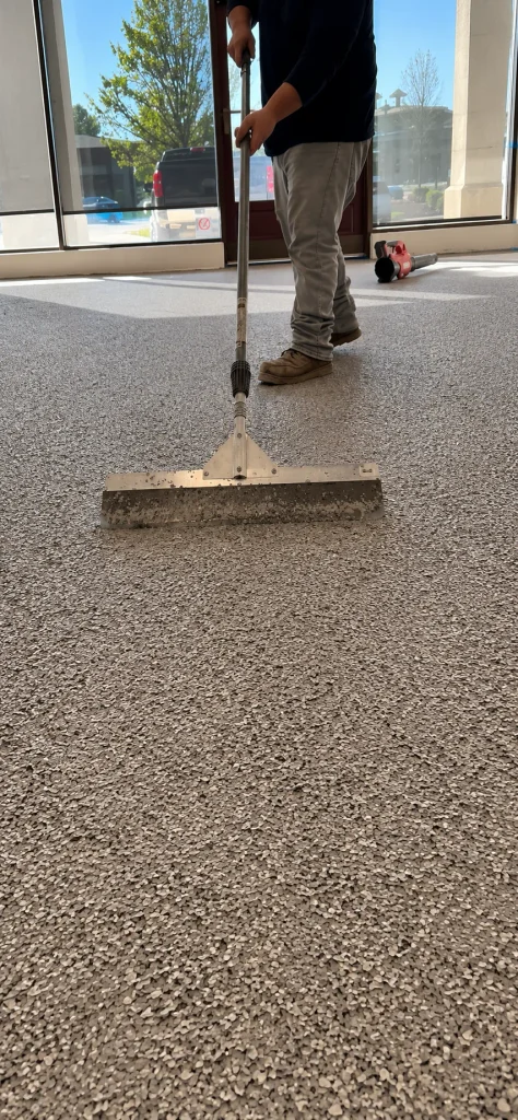 Scraping dried flake smooth with a floor scraper before the topcoat