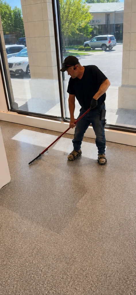 Crew member spreading the final clear layer by the front windows