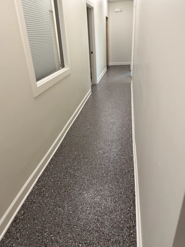 Same office hallway after a gray flake epoxy floor
