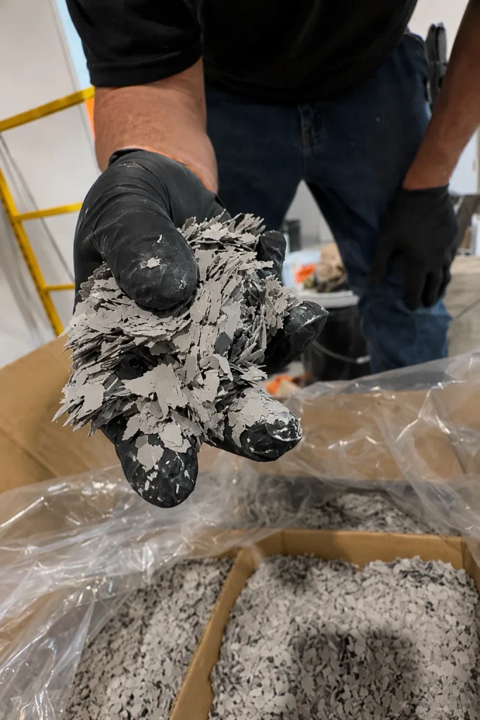 Handful of gray and white epoxy flake chips